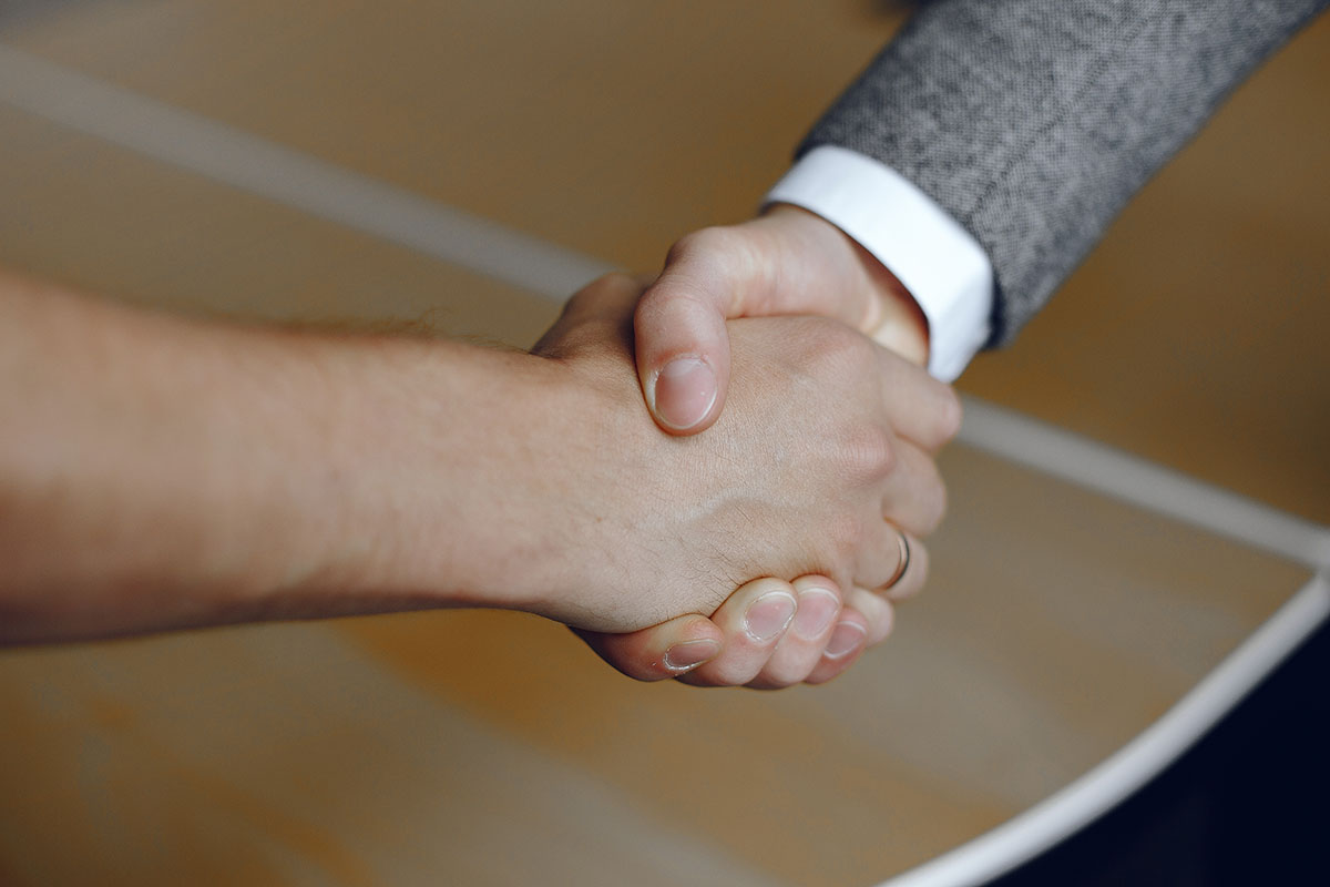 Close-up image of a firm handshake. Man standing for a trusted partnership.